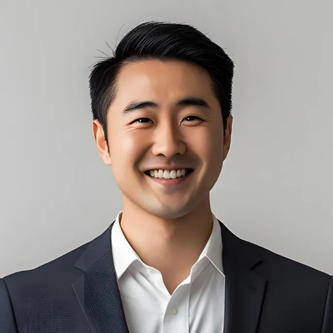 A young man in a dark suit and white shirt smiling confidently against a plain background, representing innovation, approachability, and professionalism in a legit online casino business.